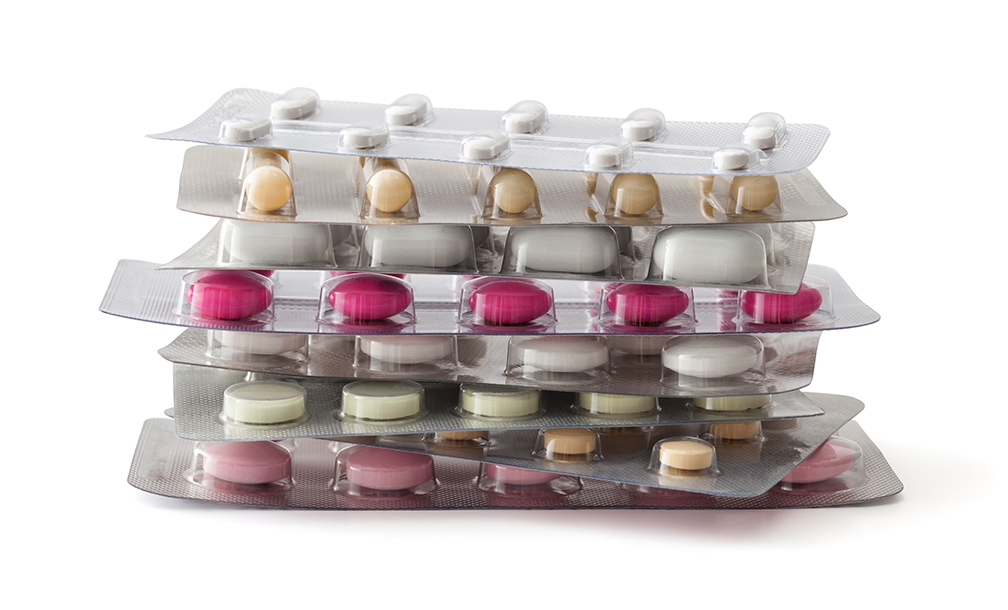 A stack of packaged pills arranged on top of each other