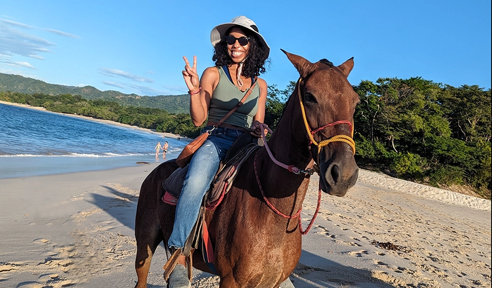 AssurX Stephanie Ojeda Life Sciences Quality and Compliance Management Professional riding a horse on the beach